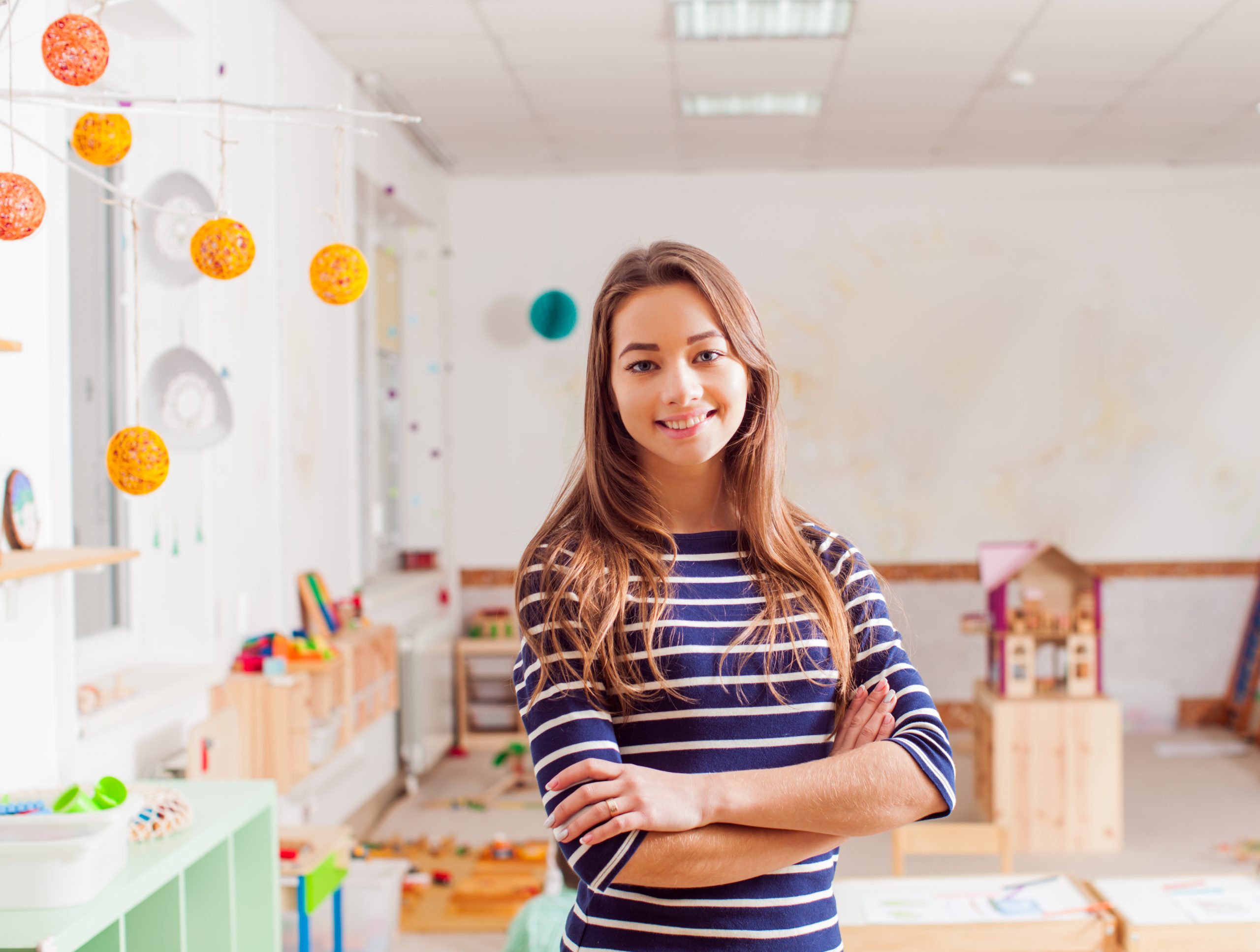 Smiling young preschool teacher in a Waldorf kindergarten