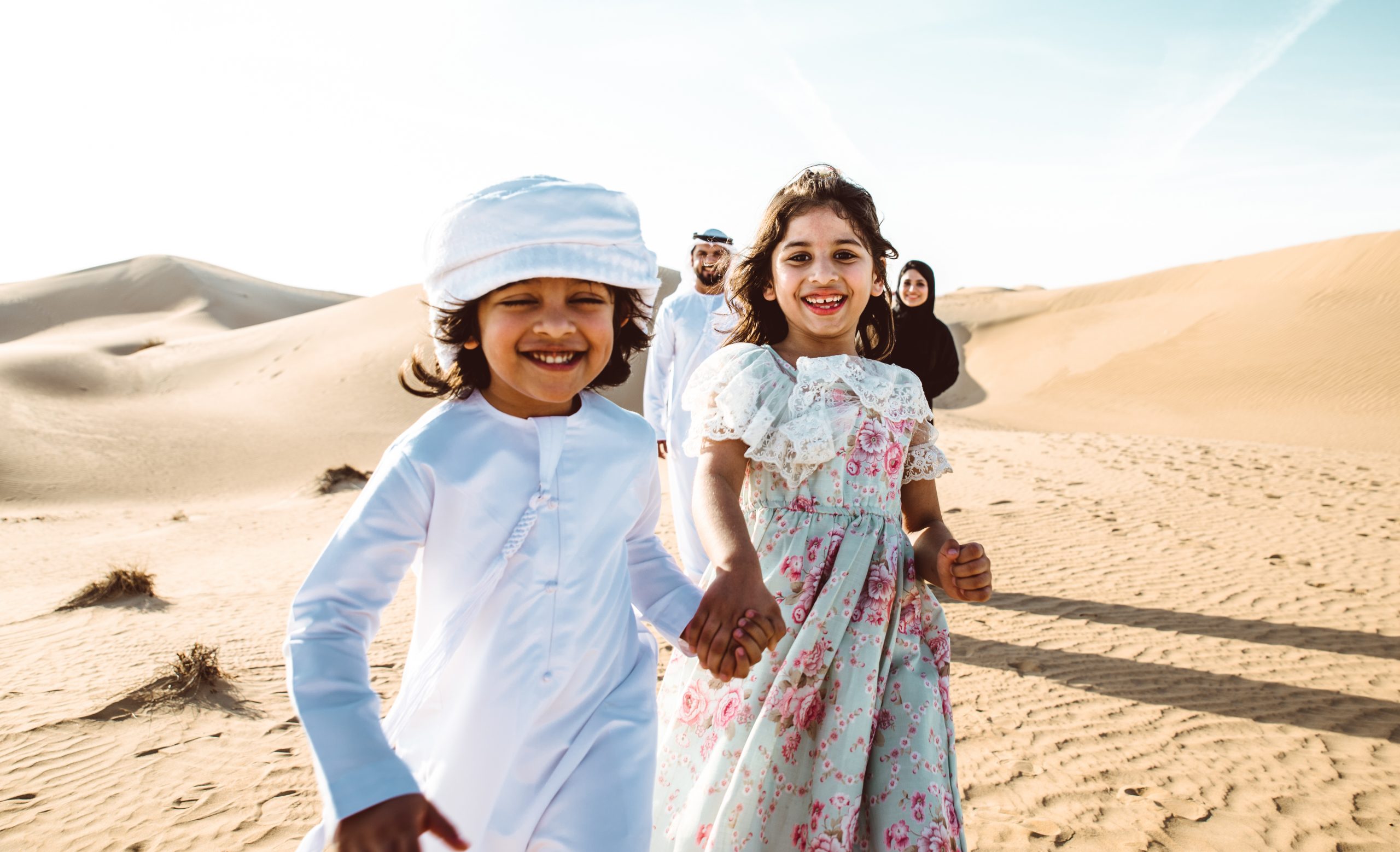 Happy family spending a wonderful day in the desert making a picnic